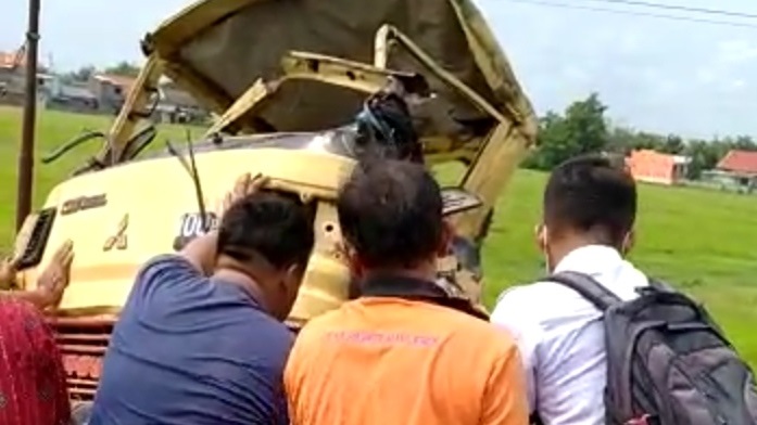 Truk didorong oleh warga dari rel kereta api usai ditabrak Kereta Api Gaya Baru di perlintasan Bandar Kedungmulyo. 