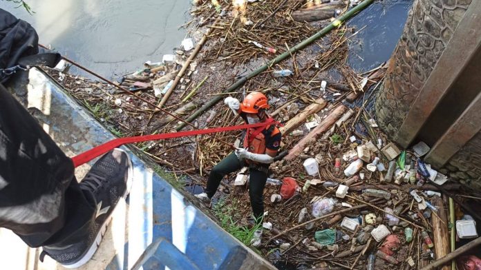 Petugas saat mengevakuasi jasad bayi.