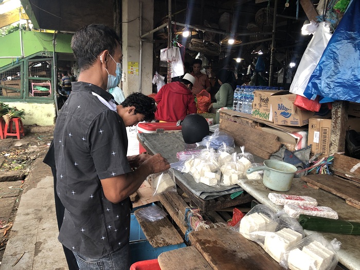 Penjual tahu tempe di Pasar Keputran merasakan dampak  atas kenaikan drastis harga kedelai hal ini membuat  stok tahu tempe yang dikirim pengrajin menurun drastis. Senin (04/01/2020). SP/ MOCHAMMAD KASYFI FAHMI  