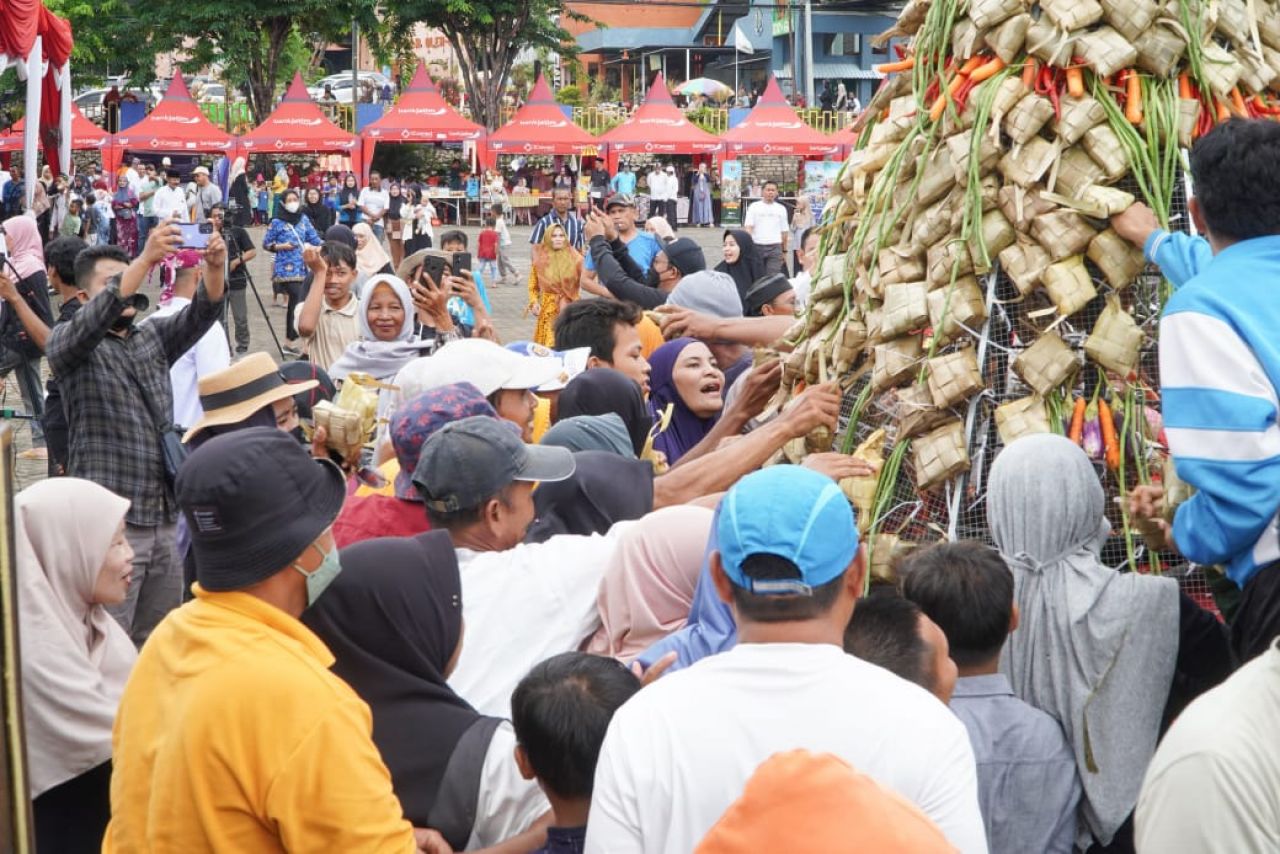 Masyarakat berebut gunungan ketupat dalam festival ketupat di WBL. SP/MUHAJIRIN 