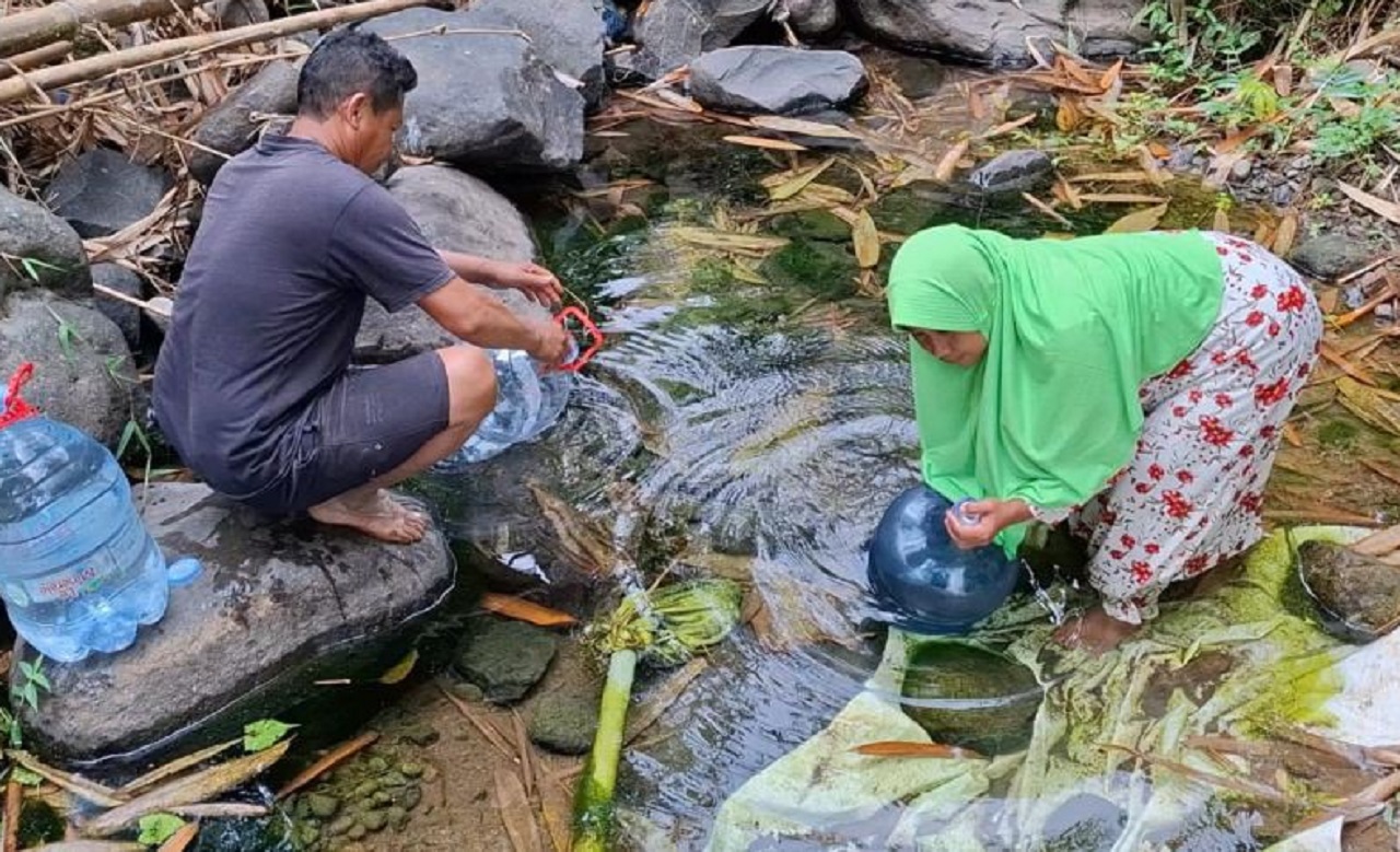 Warga berjalan sejauh 5 kilometer menuju Sungai Ngukir di Desa Ngranget, Kecamatan Dagangan Madiun untuk mengambil air bersih. SP/ MDN