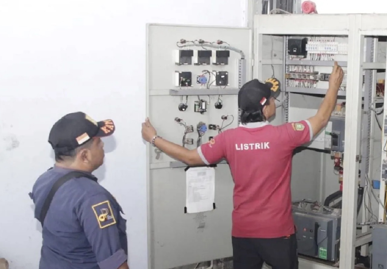 Petugas kelistrikan mengecek panel jaringan listrik di Pasar Besar Madiun. SP/ MDN