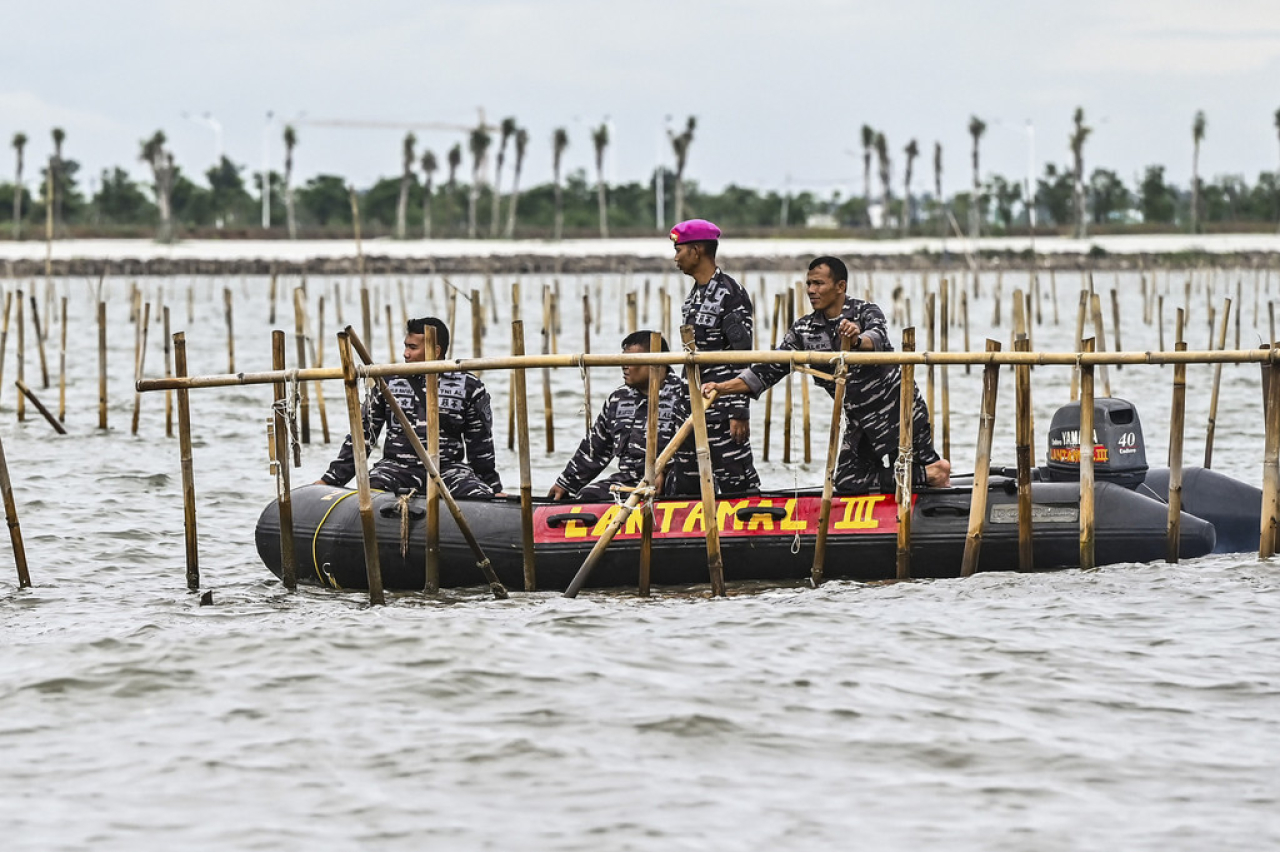 Masyarakat bersama Petugas Dinas Penyelamatan Bawah Air (Dislambair) dan Komando Pasukan Katak (Kopaska) yang dikerahkan oleh TNI AL membongkar pagar laut misterius di perairan Tangerang, Banten, Sabtu (18/1).