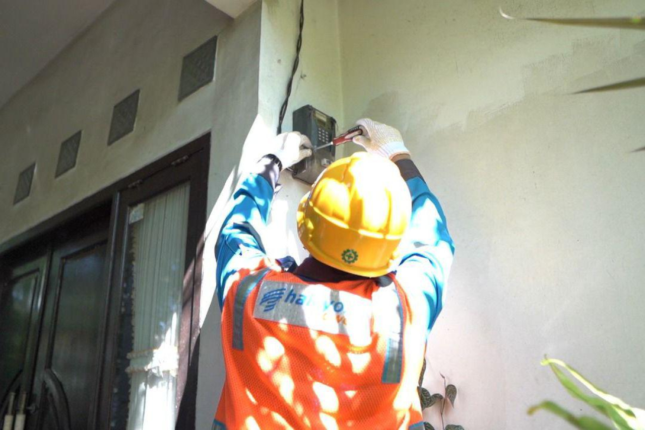 Ilustrasi Petugas PLN saat melakukan penambahan daya pada kWh meter milik pelanggan. Foto/Humas PLN