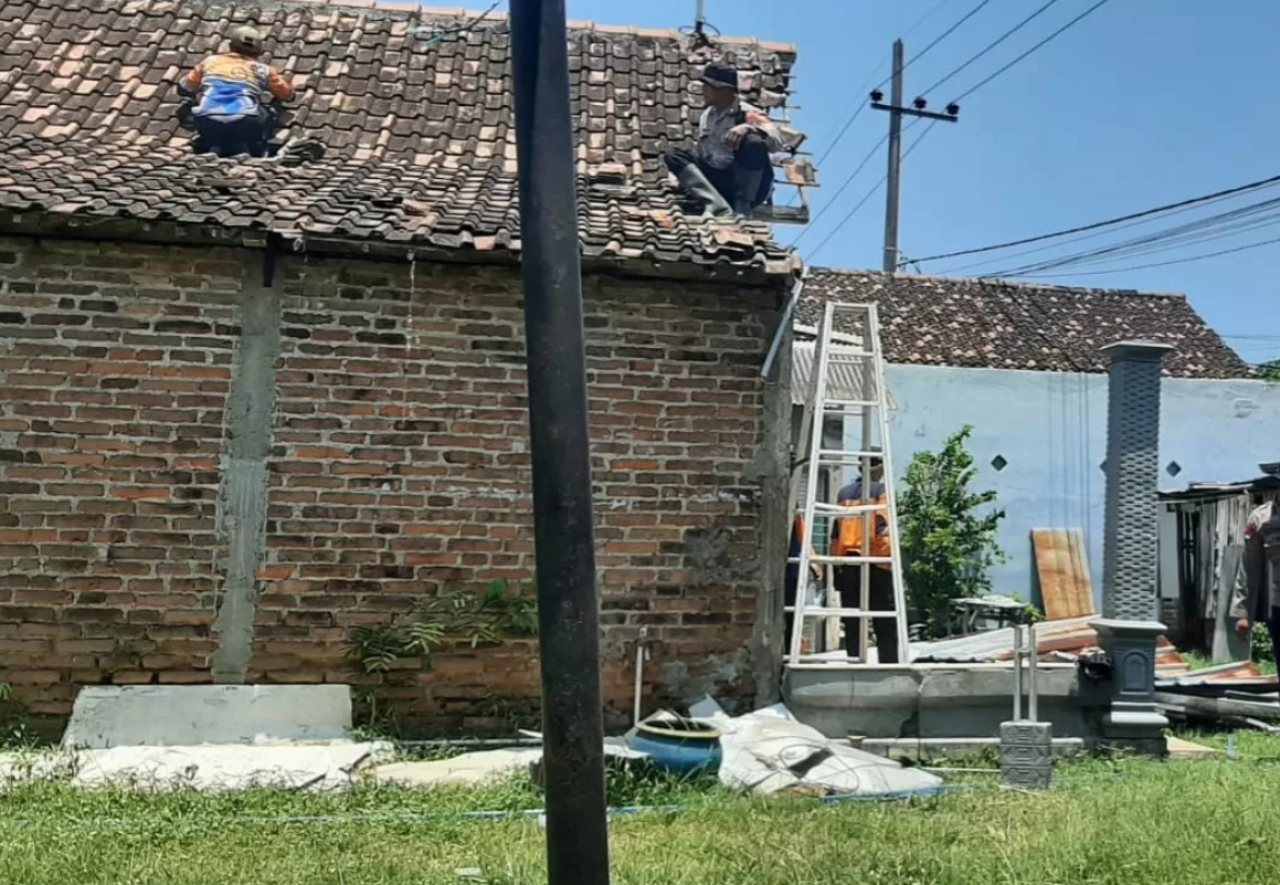 Petugas BPBD Kota Madiun mengevakuasi pohon tumbang di kawasan Kelun pascahujan deras disertai angin kencang. SP/ MDN