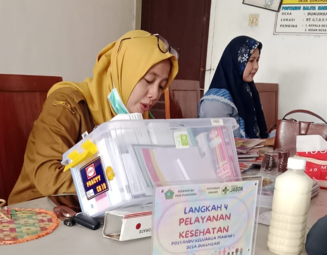 Asrin Naily, petugas Medis Puskesmas Jabon Sidoarjo saat memeriksa pasien di Posyandu Lansia. SP/Hikmah