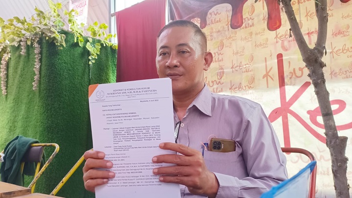Kuasa hukum PT.Superior Sarana Sukses Sukrisno Adi menunjukkan berkas laporan di Mapolres Mojokerto, Senin (13/6/2022). SP/Dwy AS