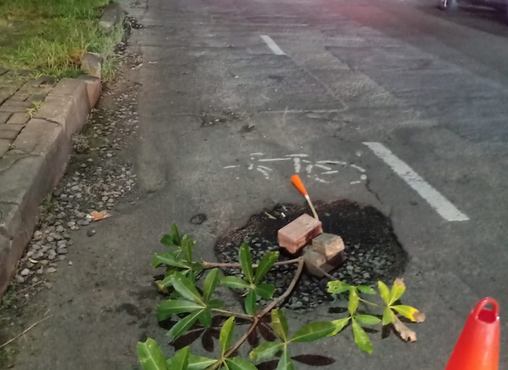 Lokasi kecelakaan ditandai dengan daun oleh warga