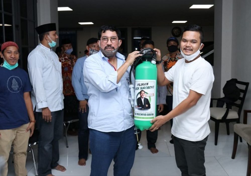 Mahfud menyerahkan cairan desinfektan dan alat. SP/ALQ