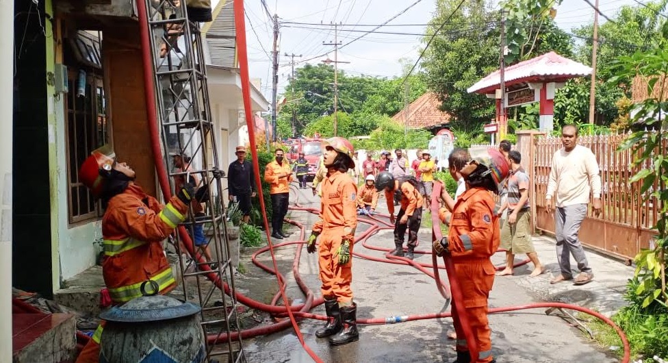 Petugas damkar saat memadamkan api yang membakar bangunan. SP/Ariandi
