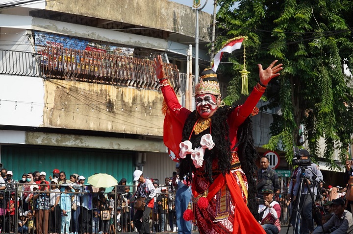 Warna-warni kostum peserta Pawai Pembangunan menarik perhatian warga yang hadir menyaksikan