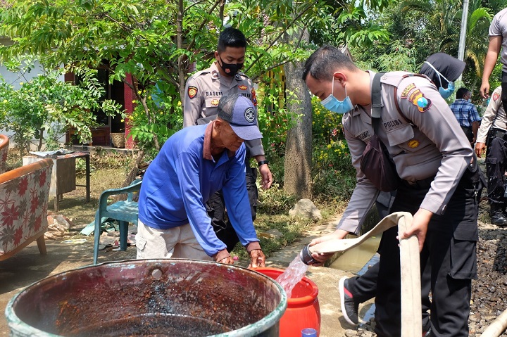 Kapolres Lumajang AKBP Eka Yekti Hananto Seno saat membagikan air bersih kepada masyarakat. SP/Lim