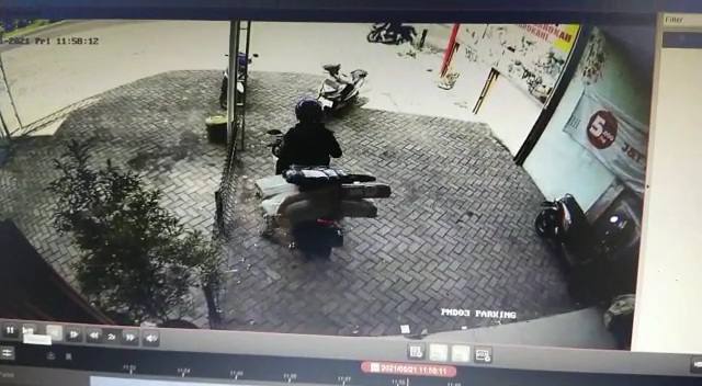 Tangkapan layar rekaman CCTV saat pelaku membawa motor dan sejumlah paket ekspedisi.