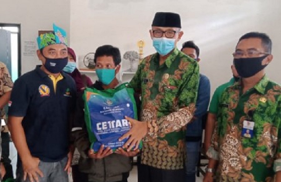 Kadinsos Pemkab Jember Widi Prasetyo saat memberikan bantuan sembako. SP/ JT