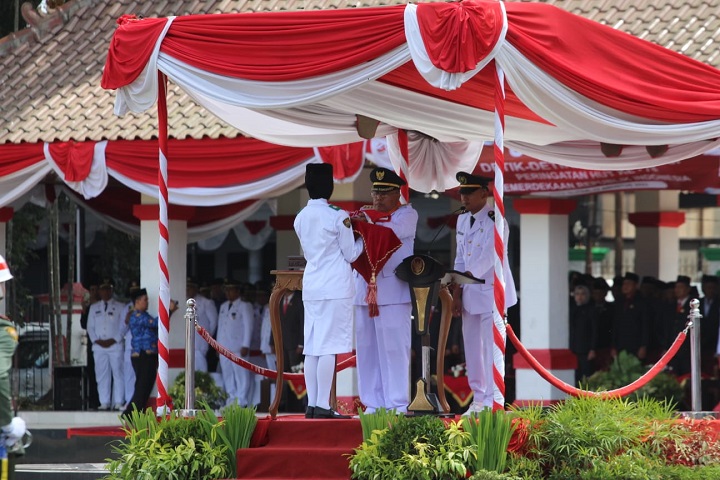  Wali kota Blitar Drs H Santoso M.Pd selaku inspektur upacara menyerahkan baki yang berisi bendera merah putih yang diterima oleh Sania Mai Rezeki siswi kelas 11 SMA Negeri 3 Kota Blitar. SP/Lestariono