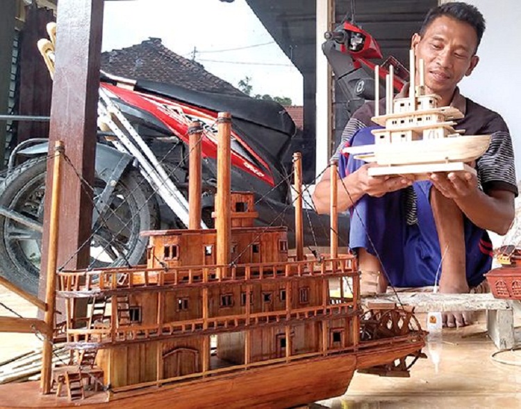 Budiono menunjukan minatur kapal yang setengah jadi. SP/ TLG