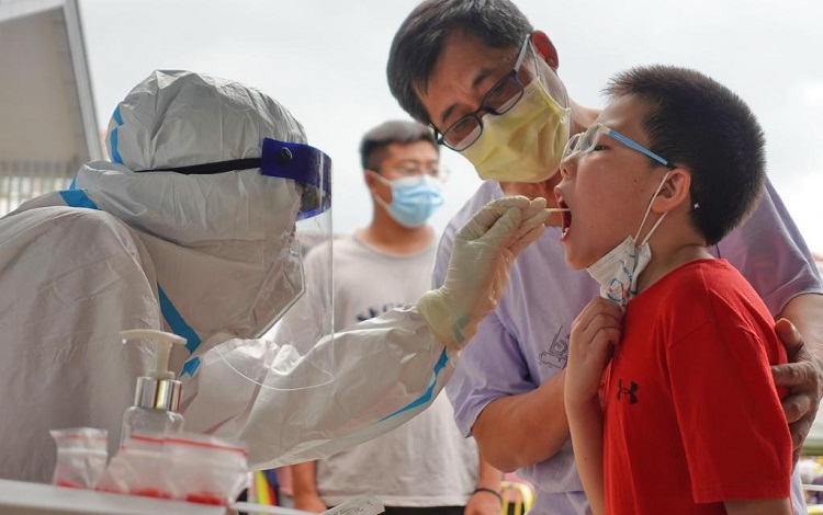 Seorang pekerja medis mengambil sampel swab untuk tes Covid-19 di lokasi pengujian di Distrik Laishan, Yantai, Provinsi Shandong, Tiongkok timur. SP/ CH