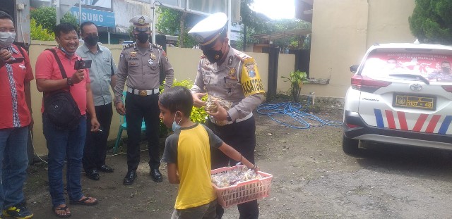 Kasatlantas Polres Blitar saat menemui bocah penjual rempeyek. SP/Hadi Lestariono