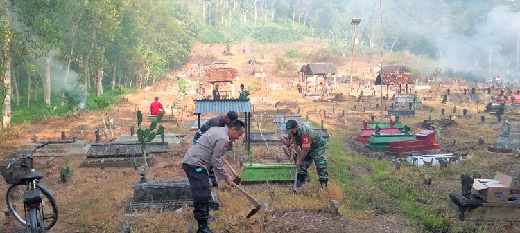 Polres dan warga Tulungagung sedang membersihkan makam umum jelang Ramadhan. SP/ Ariandi