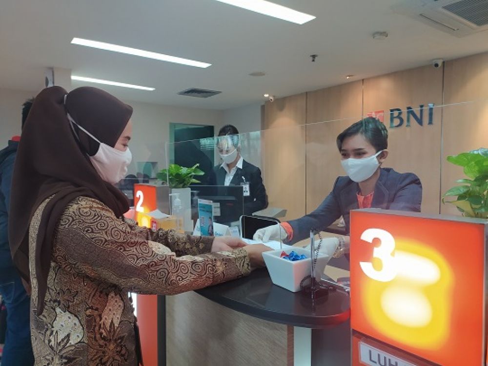 Nasabah yang  bertransaksi di outlet BNI dengan menerapka protokol kesehaan. SP/BYTA