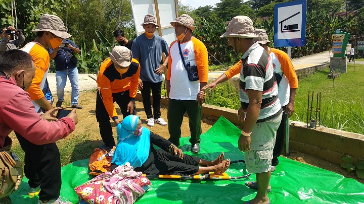 Tim siaga bencana saat mengevakuasi korban banjir yang tengah alami sakit dalam simulasi. SP/MUHAJIRIN KASRUN