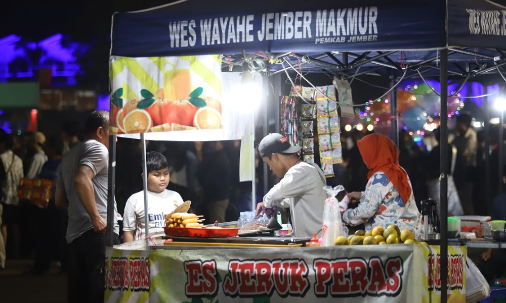 Pedagang melayani pembeli saat kegiatan nobar laga FIFA Matchday IIndonesia vs Argentina di Alun-alun Jember, Senin (19/6/2023). Foto: Diskominfo Jember.