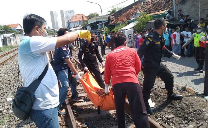 Petugas saat mengevakuasi jenazah korban.