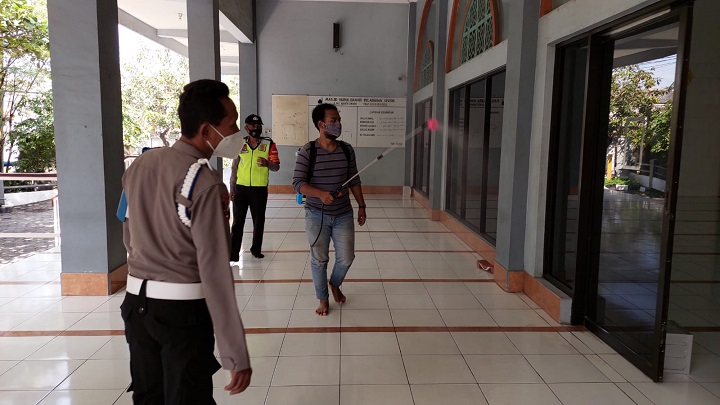 Petugas sedang melakukan penyemprotan disinfektan di Masjid Nurul Bahari komplek Pelabuhan Gresik. SP/Grs