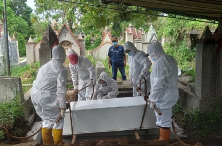 Tim pemakaman PSC 119 Kota Malang memakamkan jenazah dengan protokol Covid-19 di TPU Nasrani Sukun. SP/ SBY
