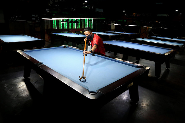 Pekerja membersihkan fasilitas tempat hiburan atau Rekreasi Hiburan Umum Break Shot menggunakan cairan disinfektan.SP/IDX